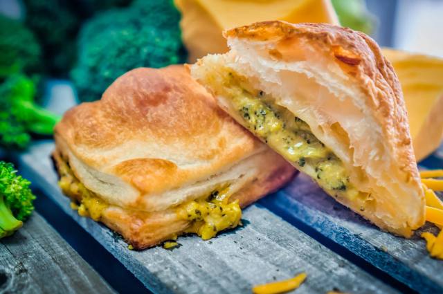 A flaky savory mini puff pastry pie cut open to show its filling