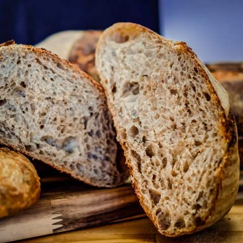 A sliced bakery loaf showing its airy crumb and golden crust