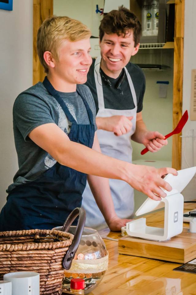 Bakers shaping pastry dough by hand at the workbench