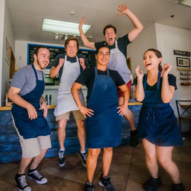 The Buttered Up bakery team shaping laminated pastry dough together