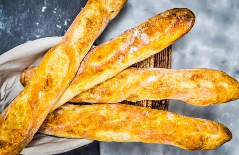 Golden baguettes cooling in the bakery