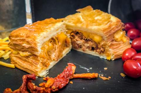 A stacked croissant lunch sandwich cut open to show the filling